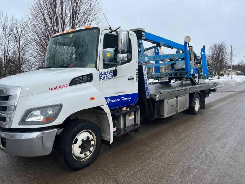 Heavy Duty Equipment on Flatbed Tow Truck - Forklift Towing Service