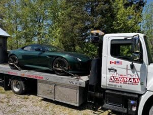 flatbed-towing-a-green-car
