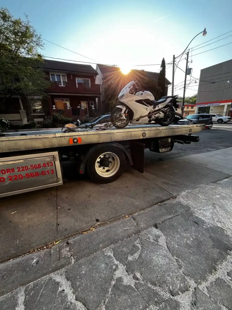 Cruiser motorcycle being towed from a roadside