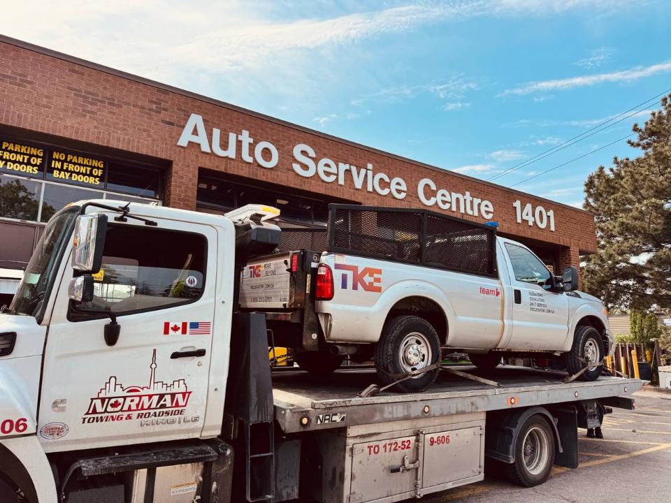 Tow truck towing a car from private property in Peel Region