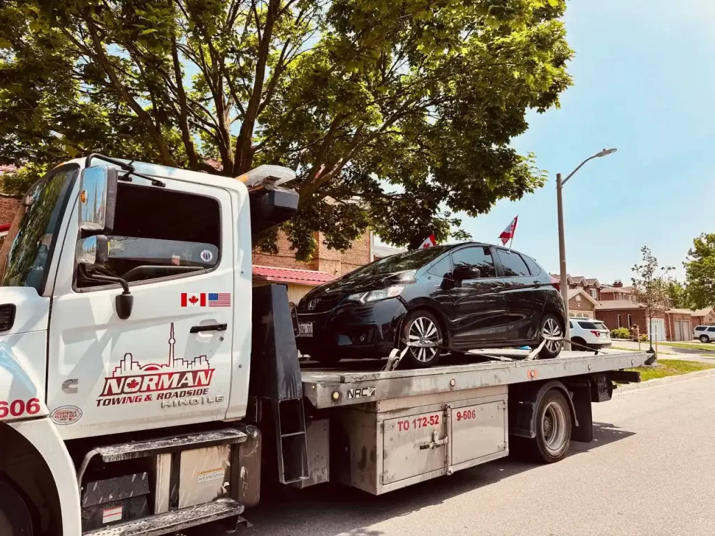 Tow truck removing an unauthorized vehicle in York Region