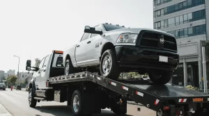 Car safely loaded on a tilt-load tow truck